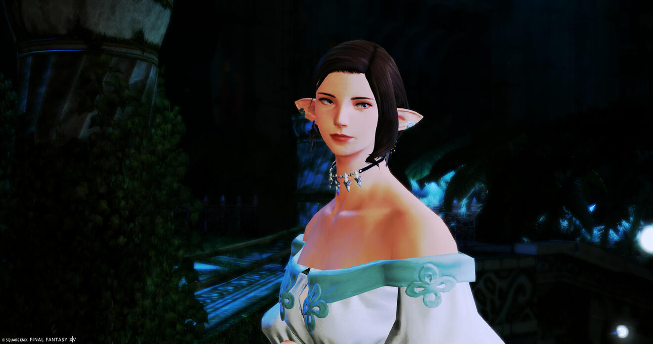 Oudine sits in front of a winged background with white orchids, smiling calmly in a white blouse (the Spring shirt from the game).